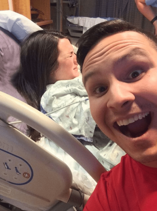 Guy taking Selfie while girl in labor